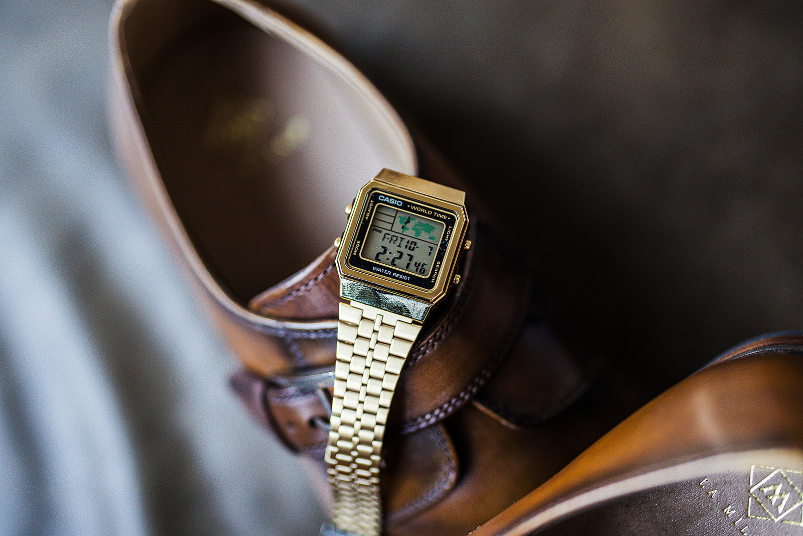 Gold Casio watch with brown leather dress shoes