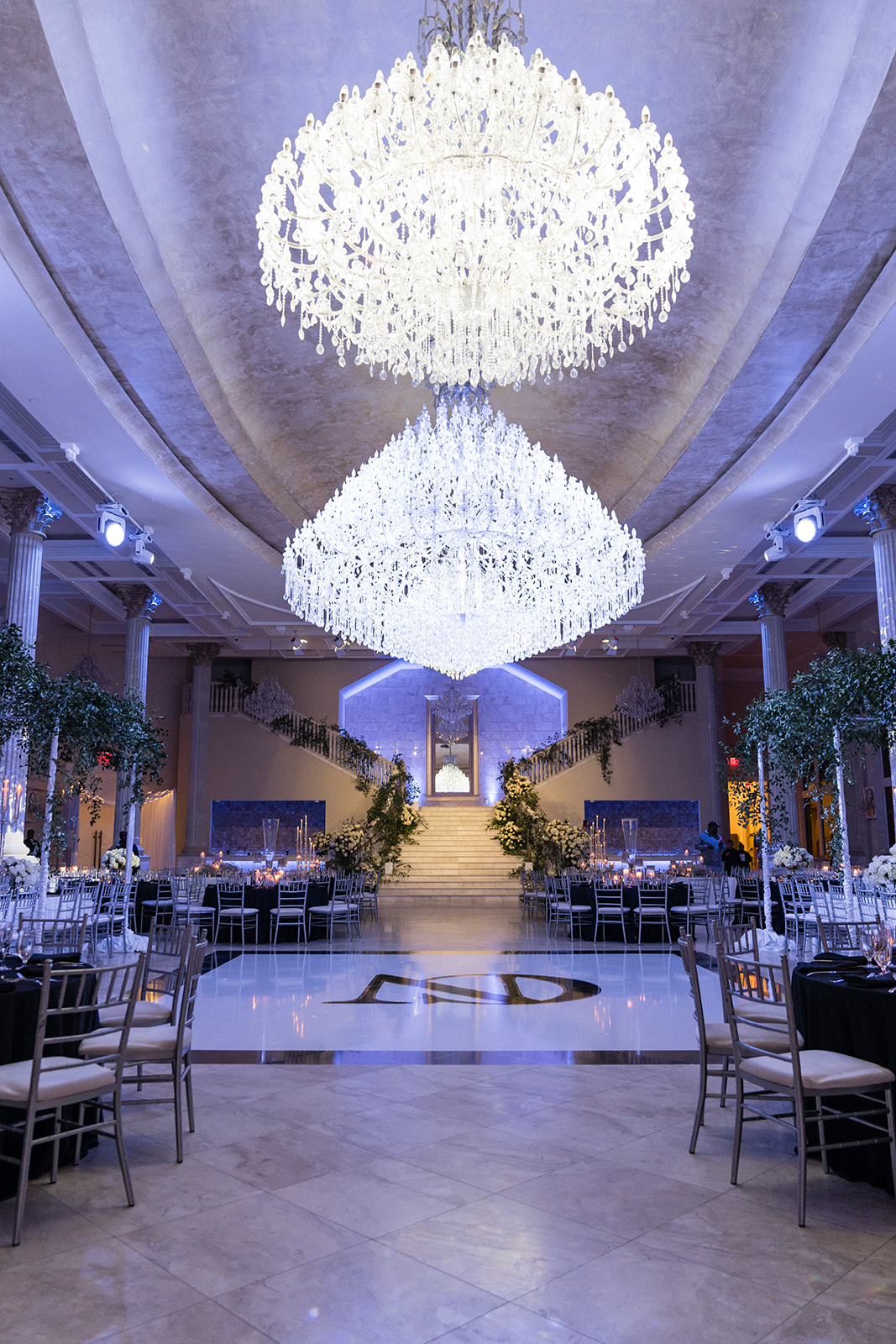 Grand ballroom with chandeliers and purple uplighting