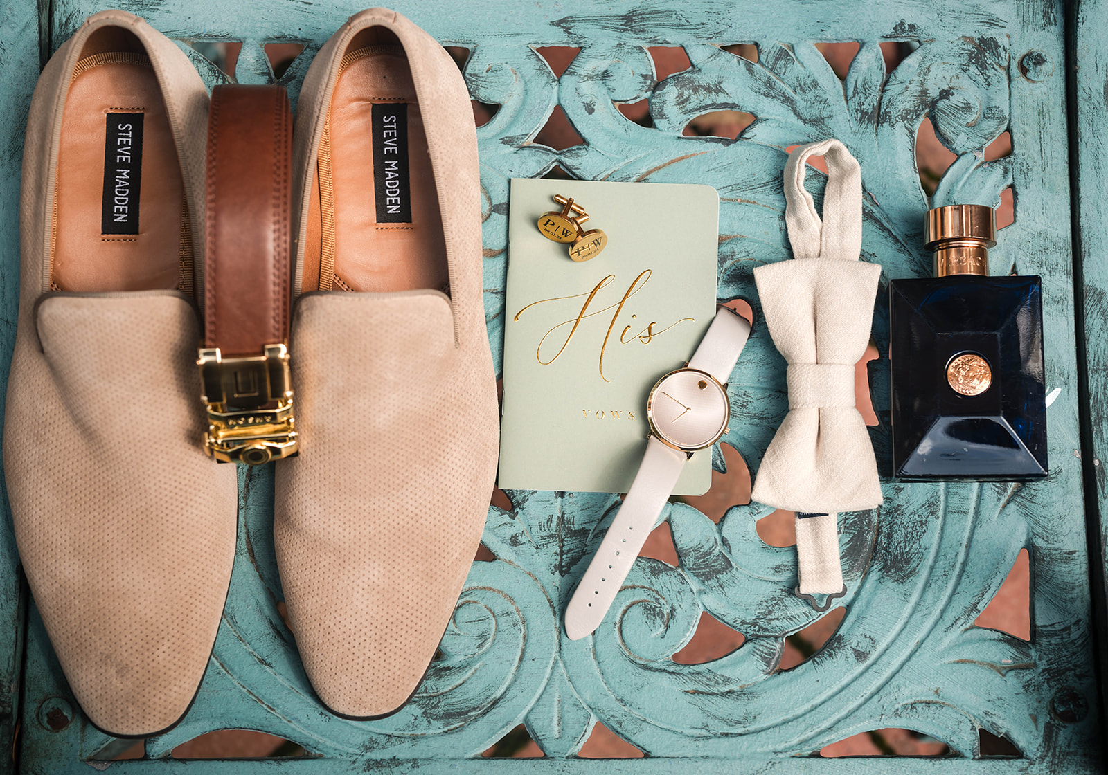 Groom flatlay with loafers vow book bowtie cologne