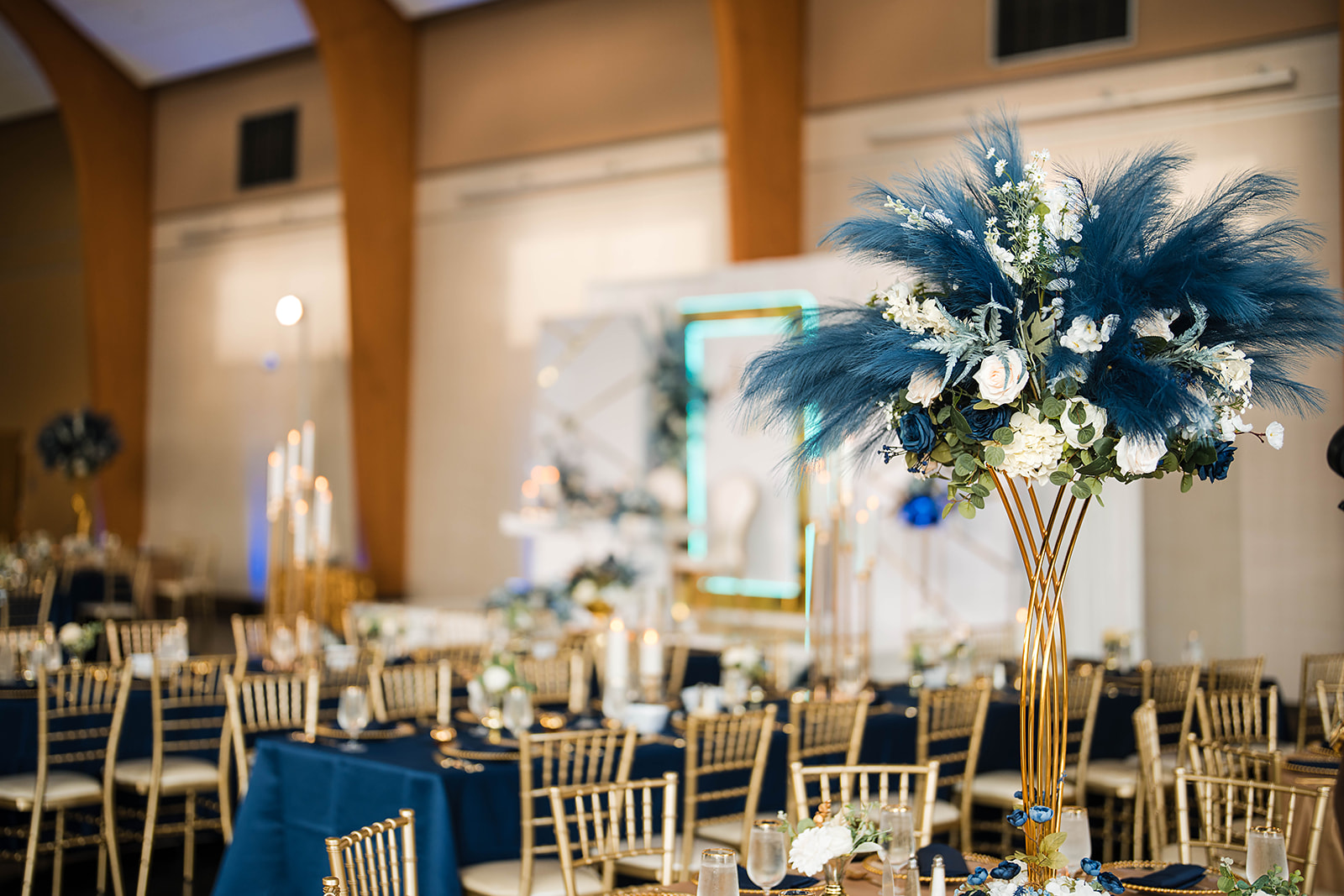 Navy and gold reception with feather centerpiece