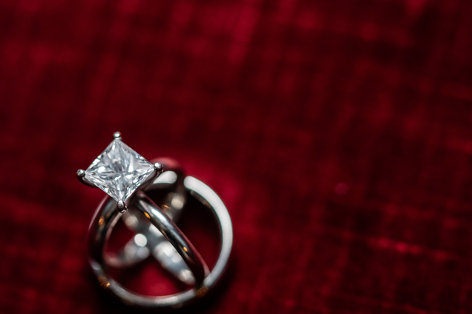 Princess cut solitaire ring on red velvet macro