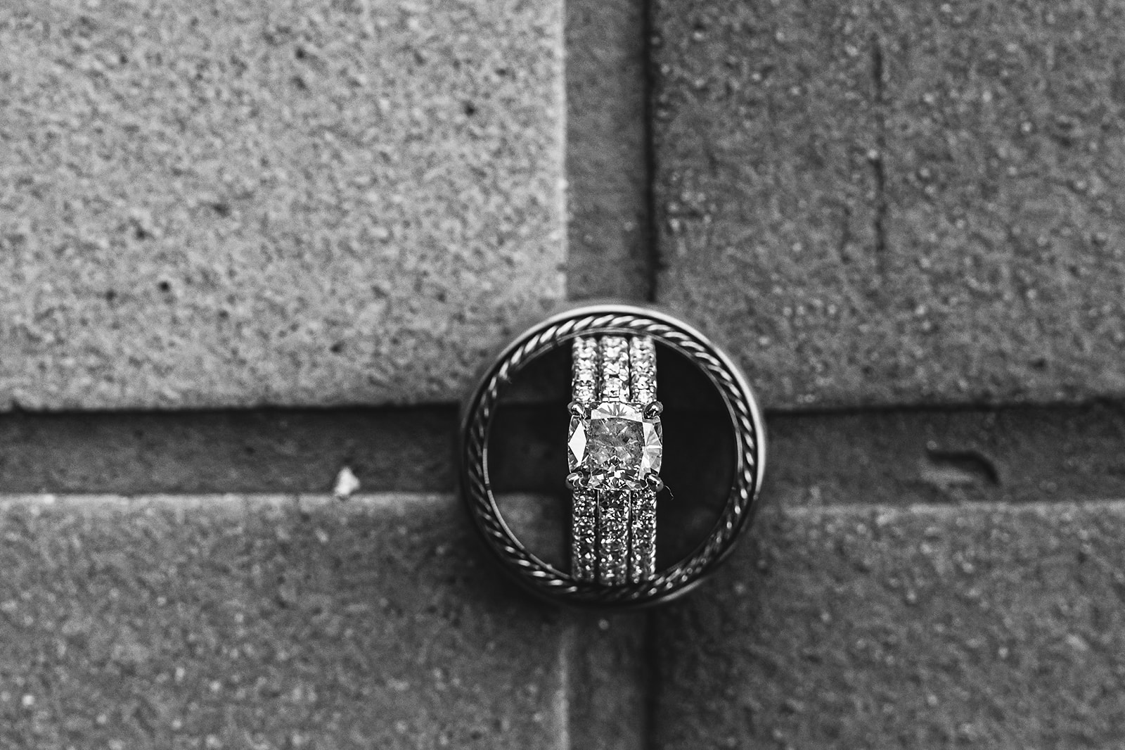 Rings nested in stone brick black and white macro