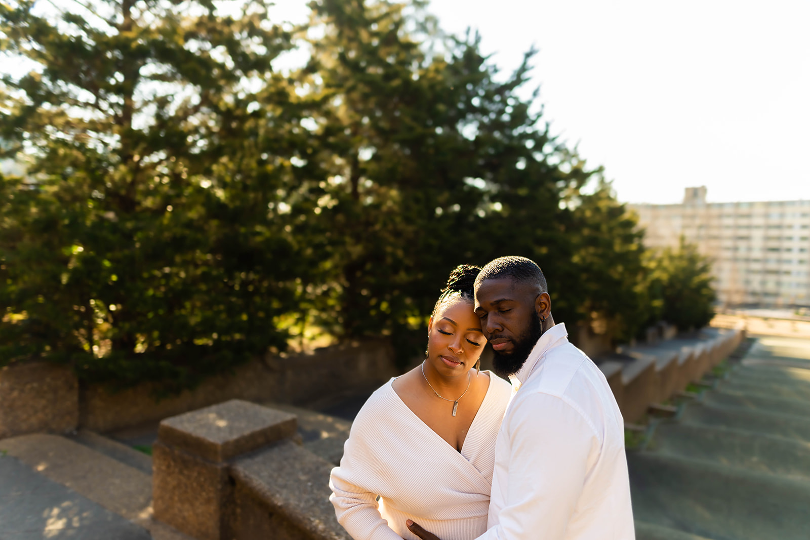 Couple embrace on rooftop at golden hour in DC
