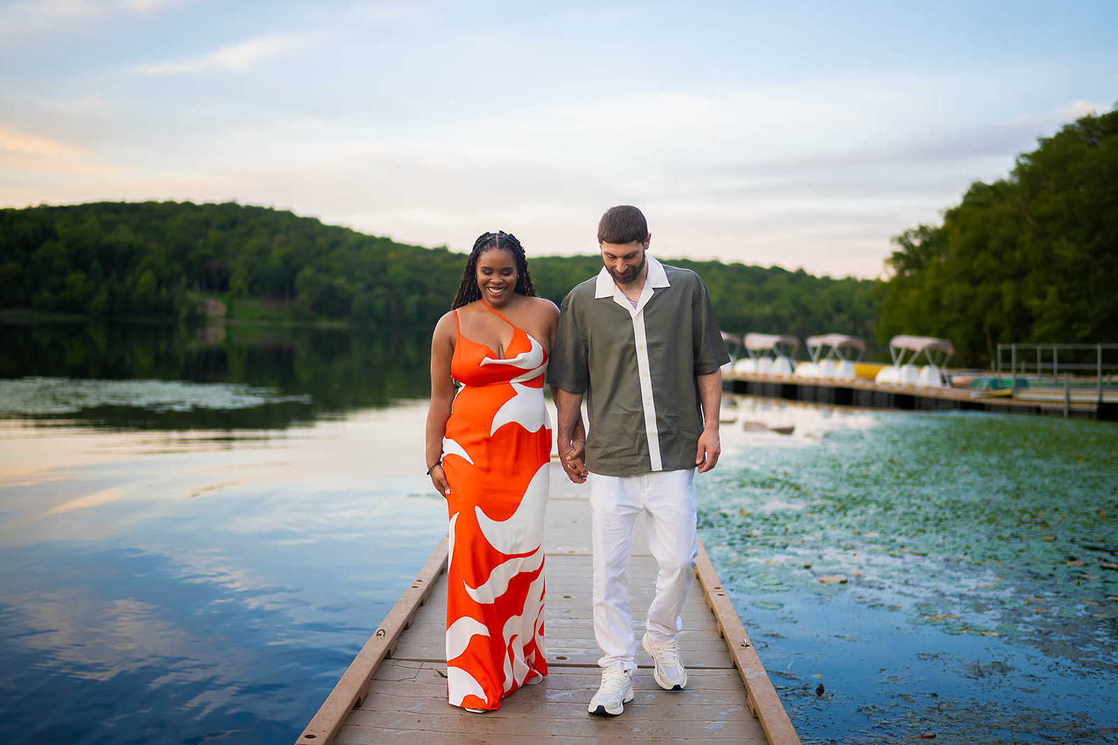 Couple walking on lake dock in summer casual