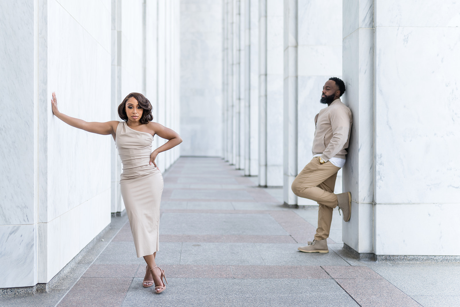 Couple editorial pose by marble columns