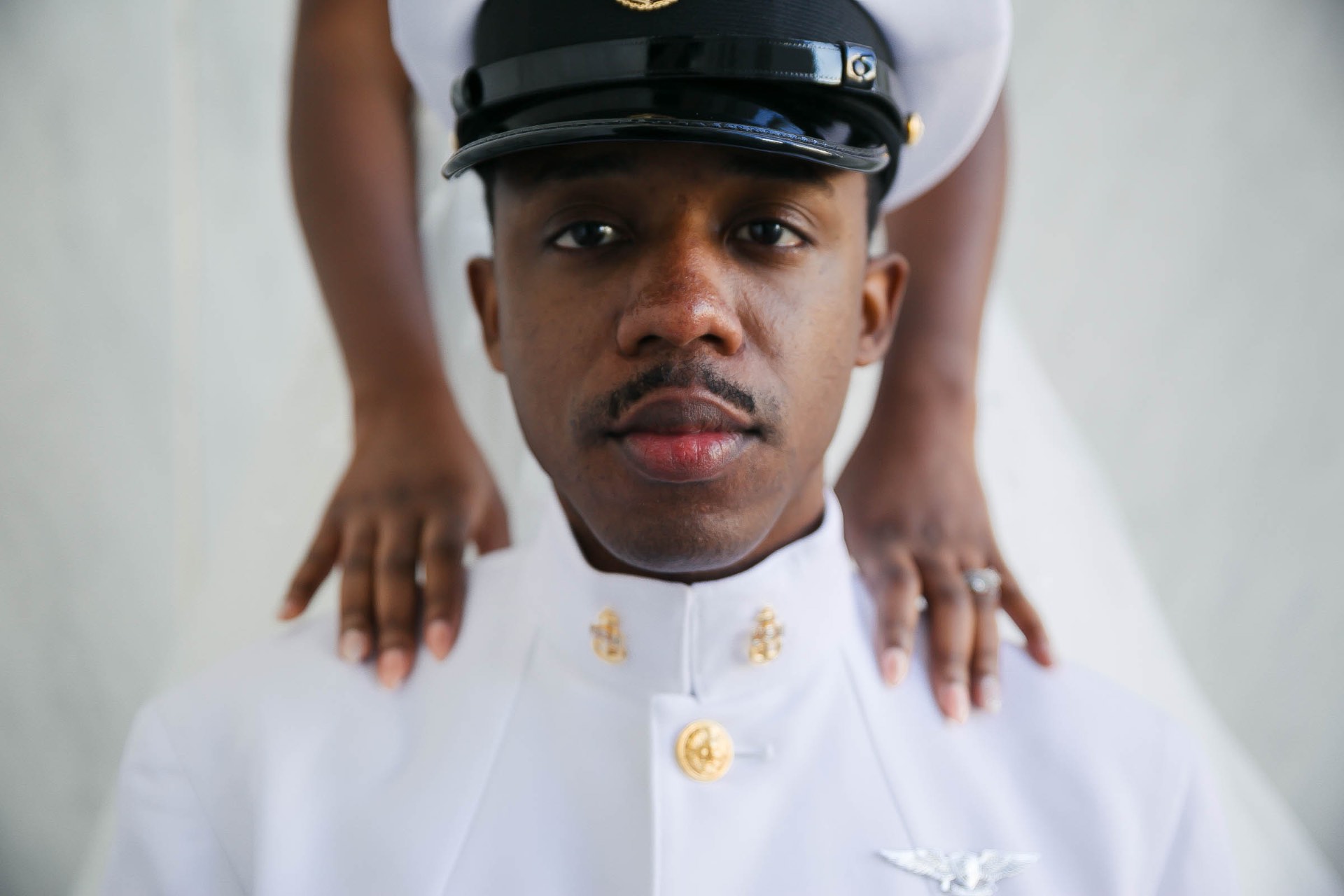 Navy officer portrait hands on shoulders closeup