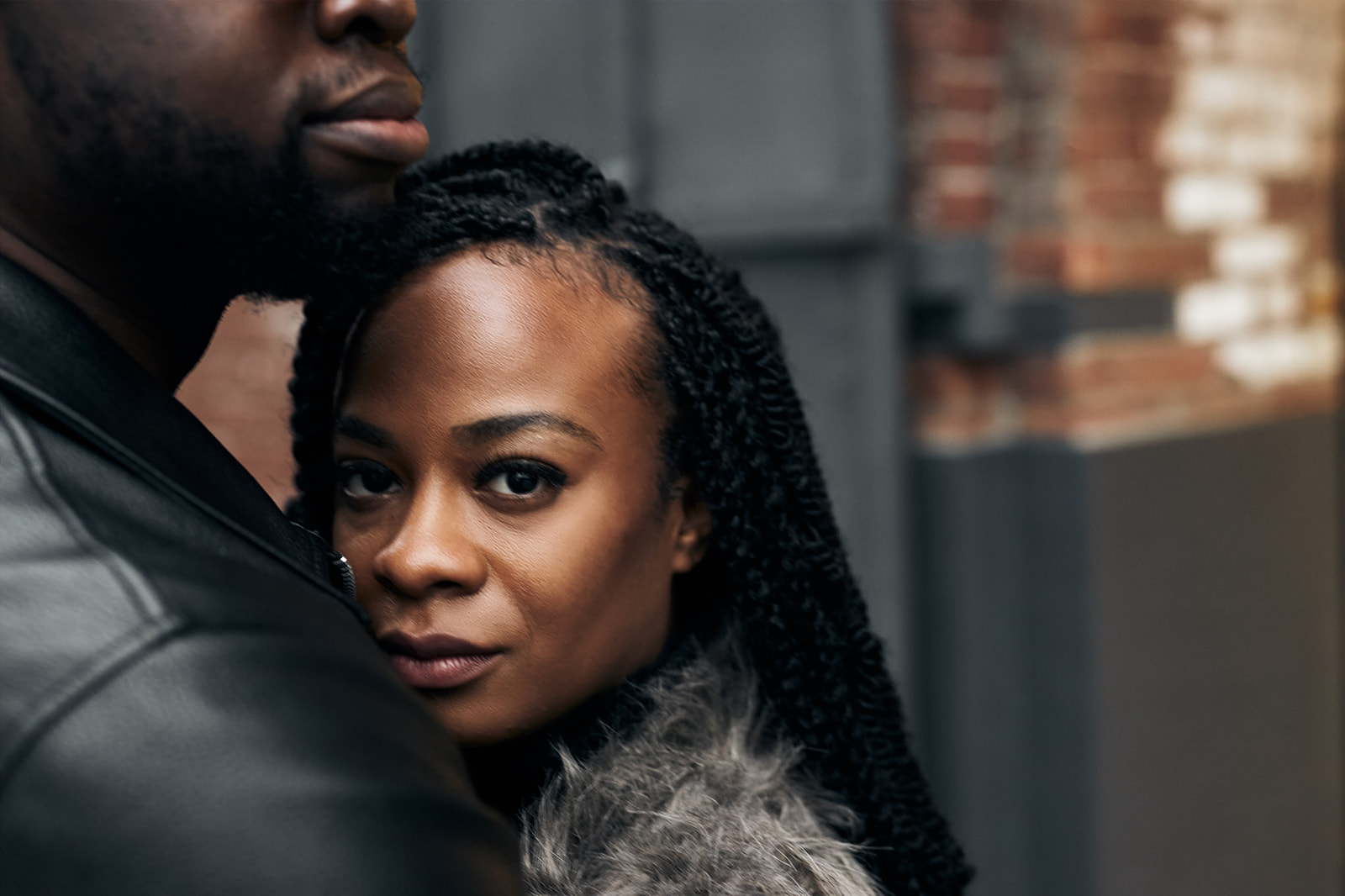 Woman closeup with braids and leather jacket urban