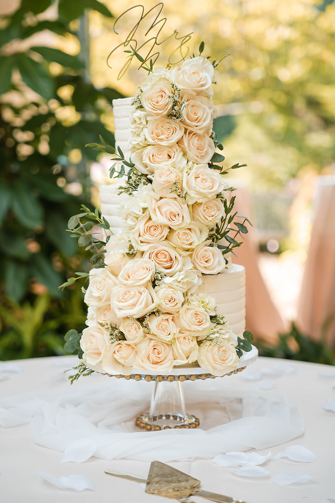 Four-tier wedding cake with cascading roses