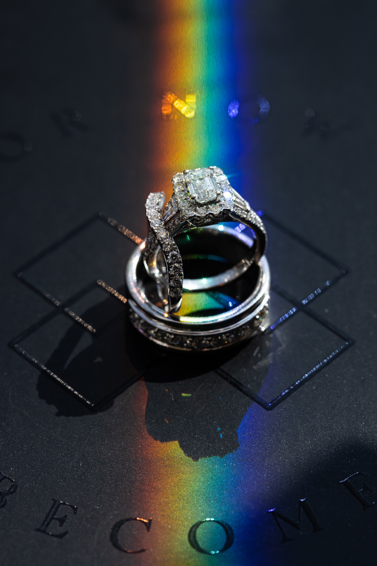 Wedding rings emerald cut halo with rainbow prism light macro