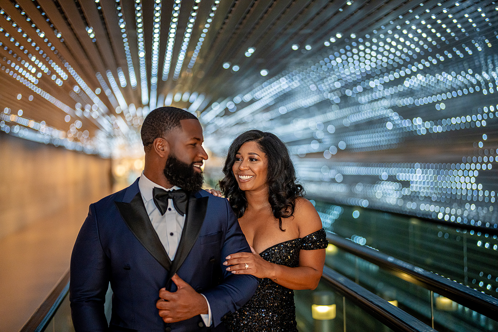 Couple in light tunnel with bokeh formal portrait
