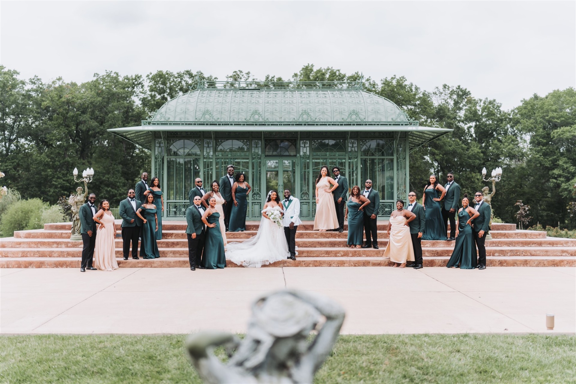 Bridal party at conservatory venue green and gold dresses
