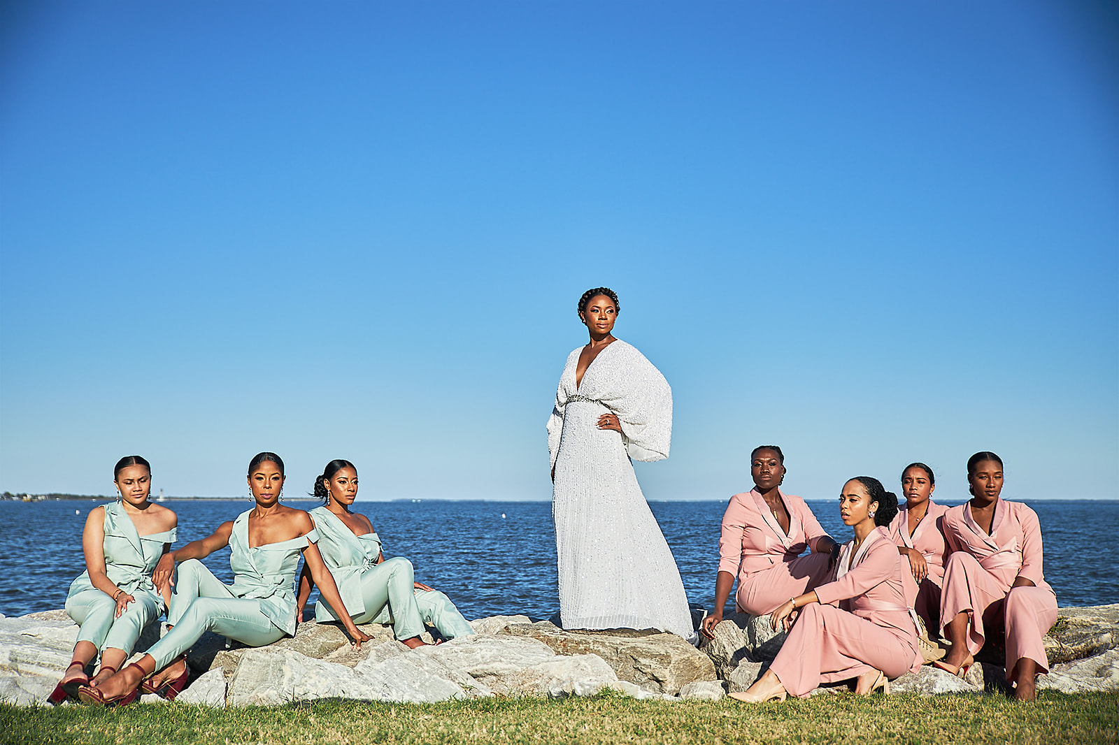 Bridal party on waterfront rocks editorial fashion portrait