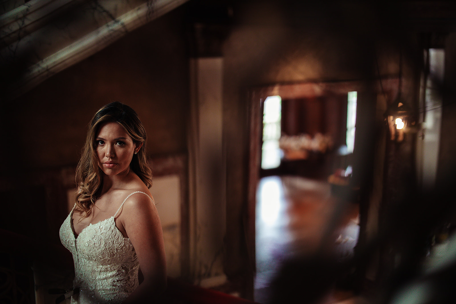 Bride moody portrait in palace doorway with warm light