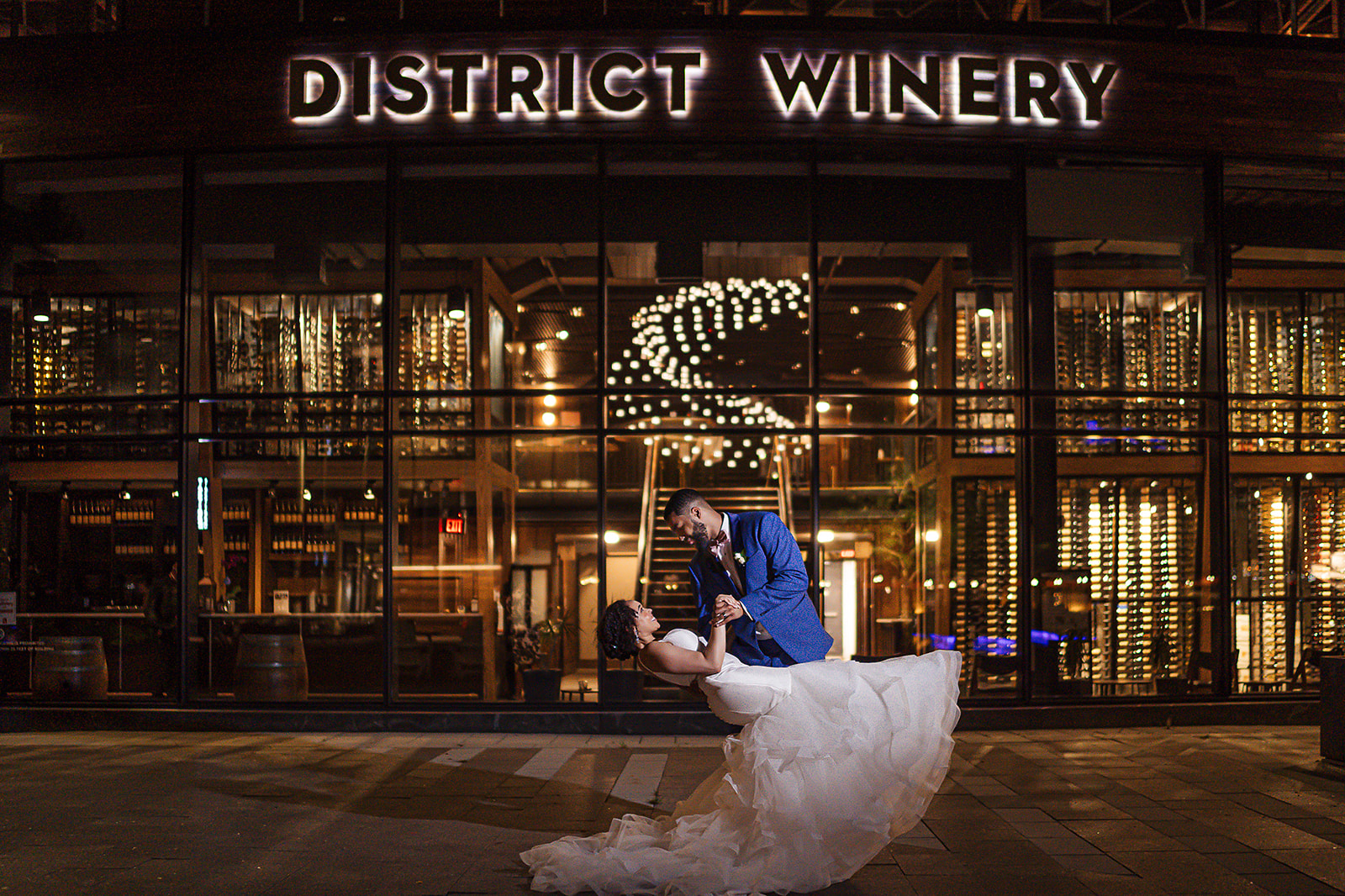 Couple dip at District Winery at night