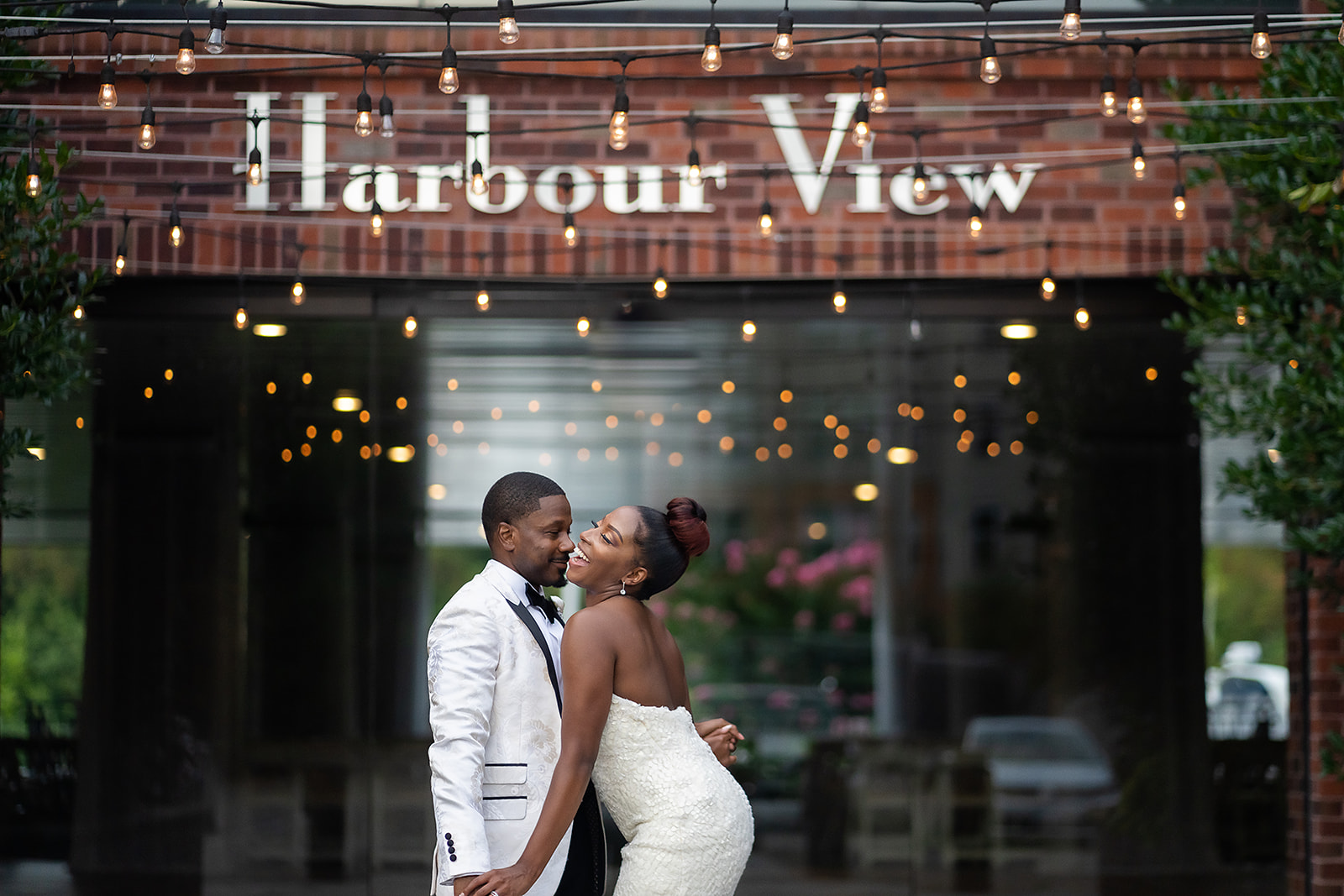 Couple at harbour view with string lights