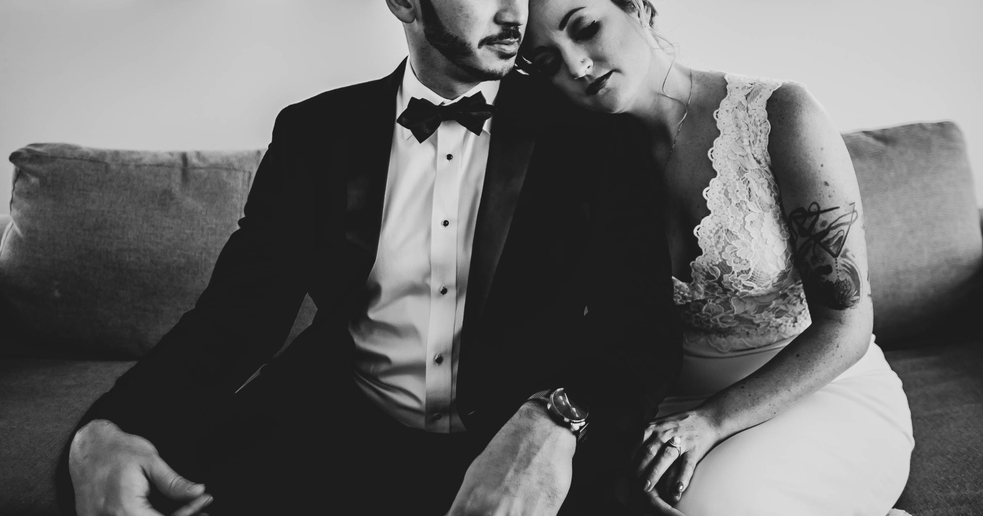 Couple intimate on couch black and white tattoo lace editorial