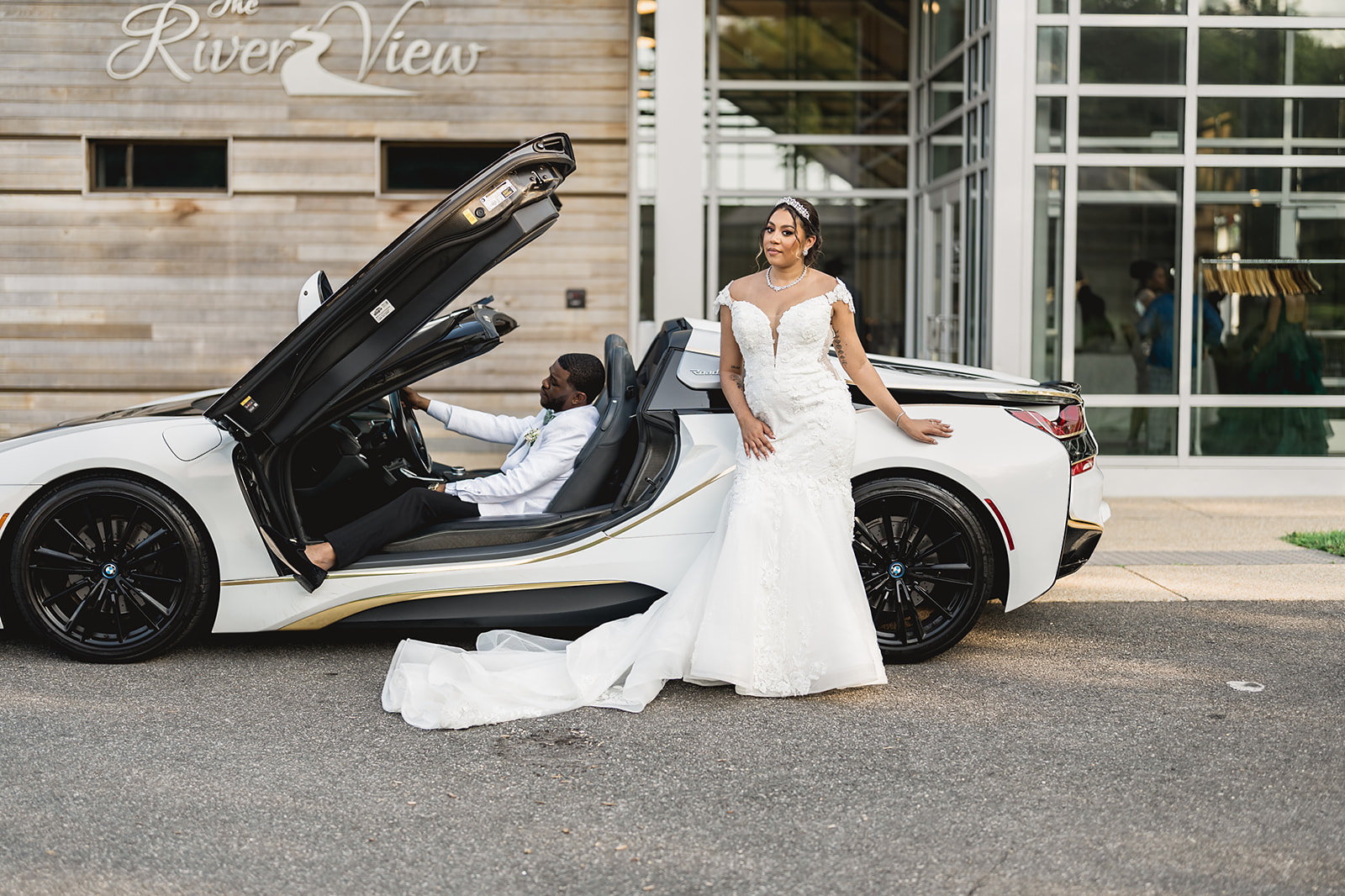 Couple with luxury car at riverview venue