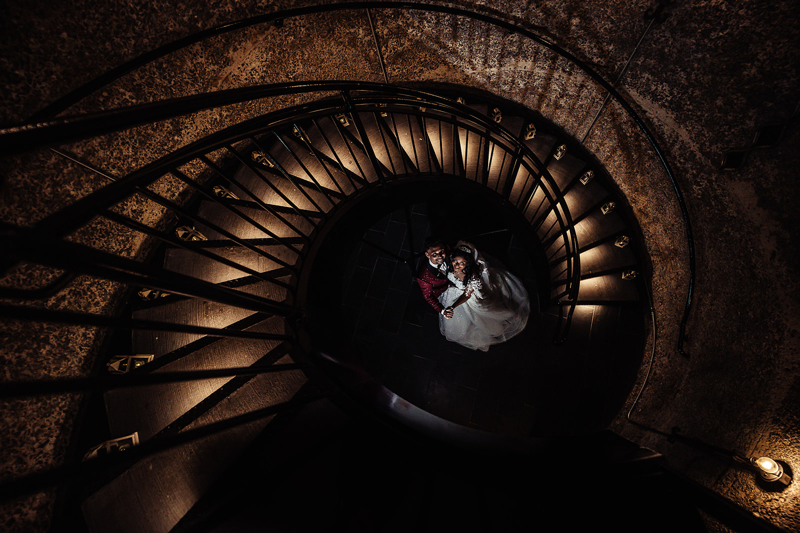 Overhead view of couple on spiral staircase