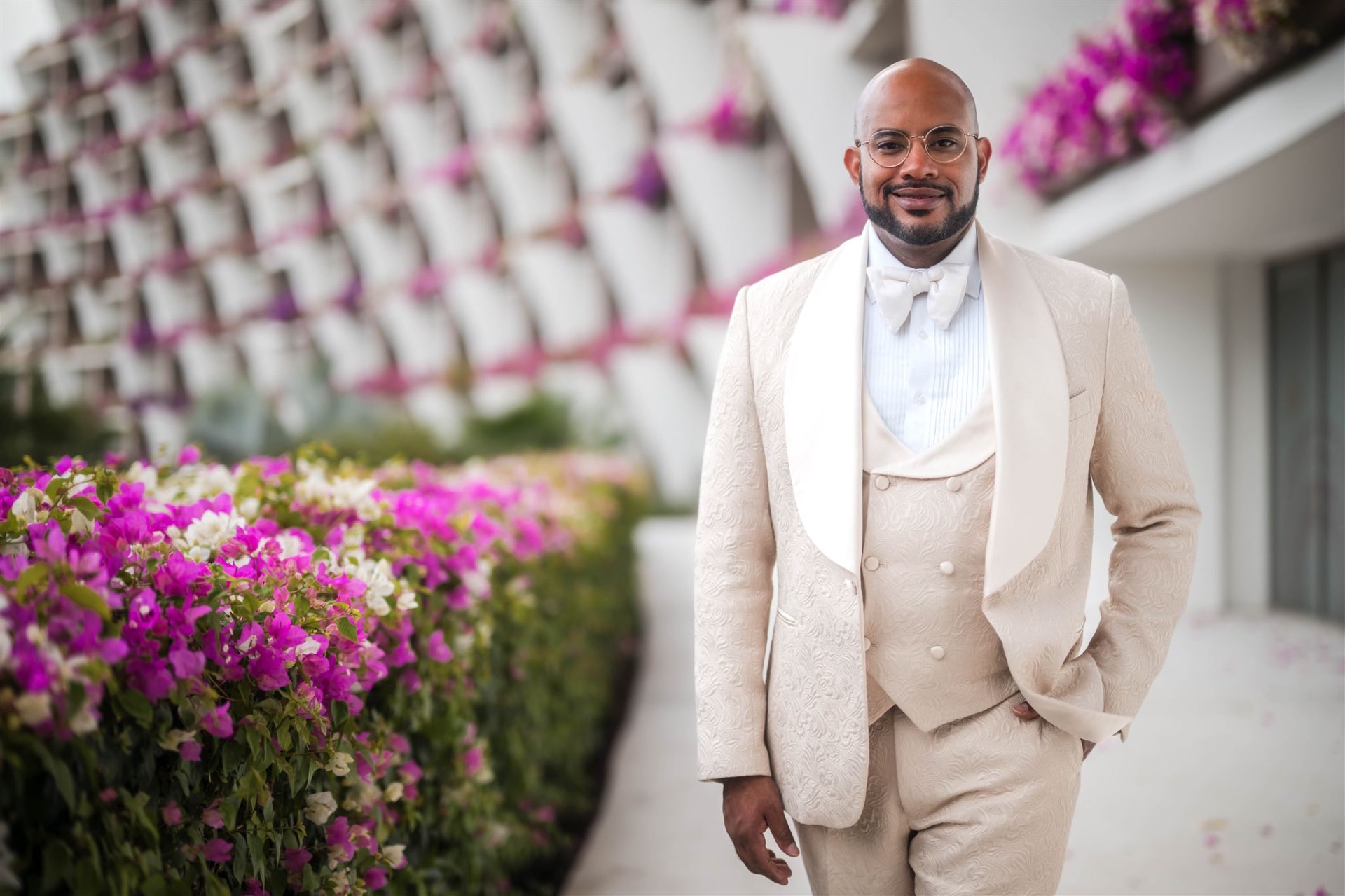 Groom in cream brocade tuxedo with bougainvillea Los Cabos destination wedding