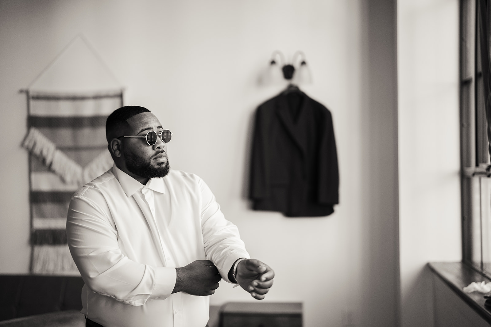 Groom getting ready with sunglasses black and white editorial