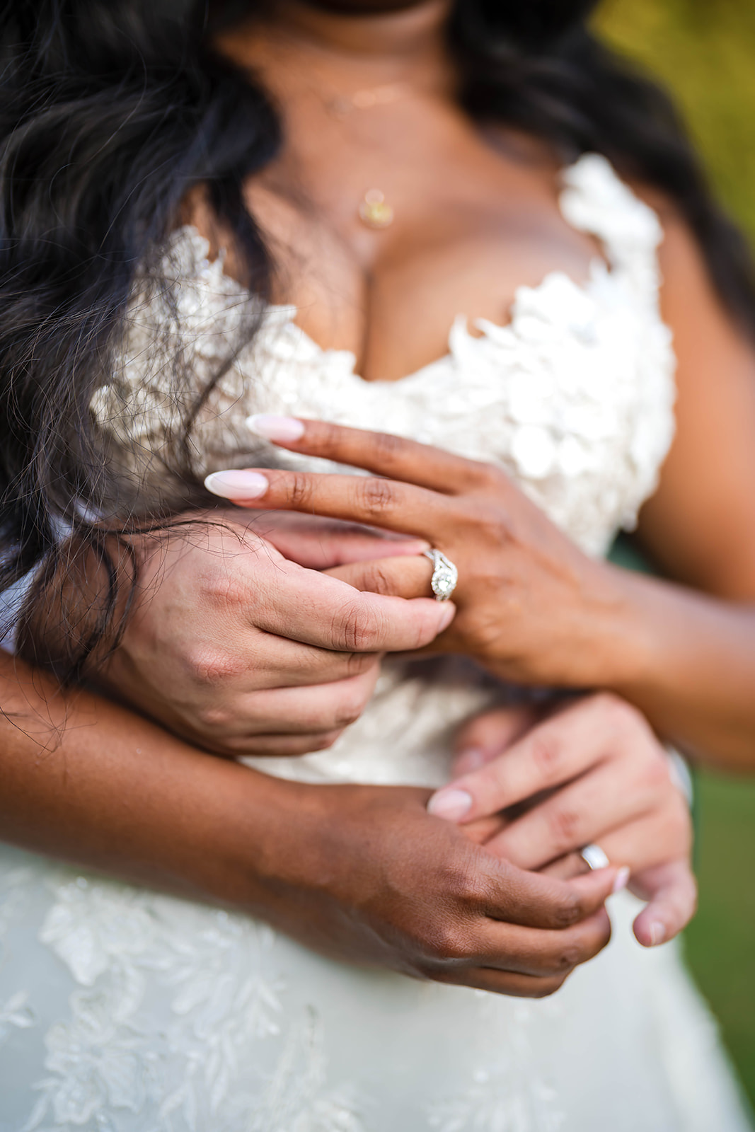 Ring detail with hands in embrace closeup